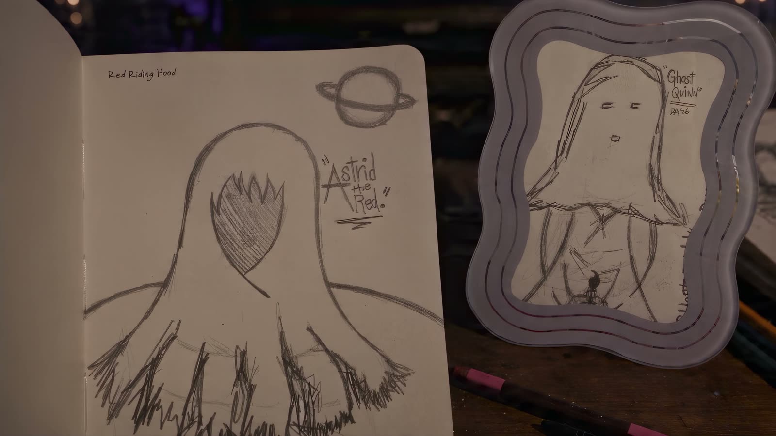 The original 'Ghost Quinn' and 'Astrid the Red' pencil sketches on a desk, the frame that holds the physical Ghost Quinn piece visible beside them.